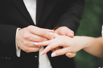 Bride and groom exchanging wedding rings. Stylish couple official ceremony