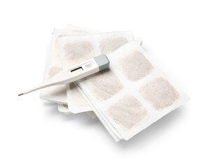 Mustard plasters with thermometer on white background