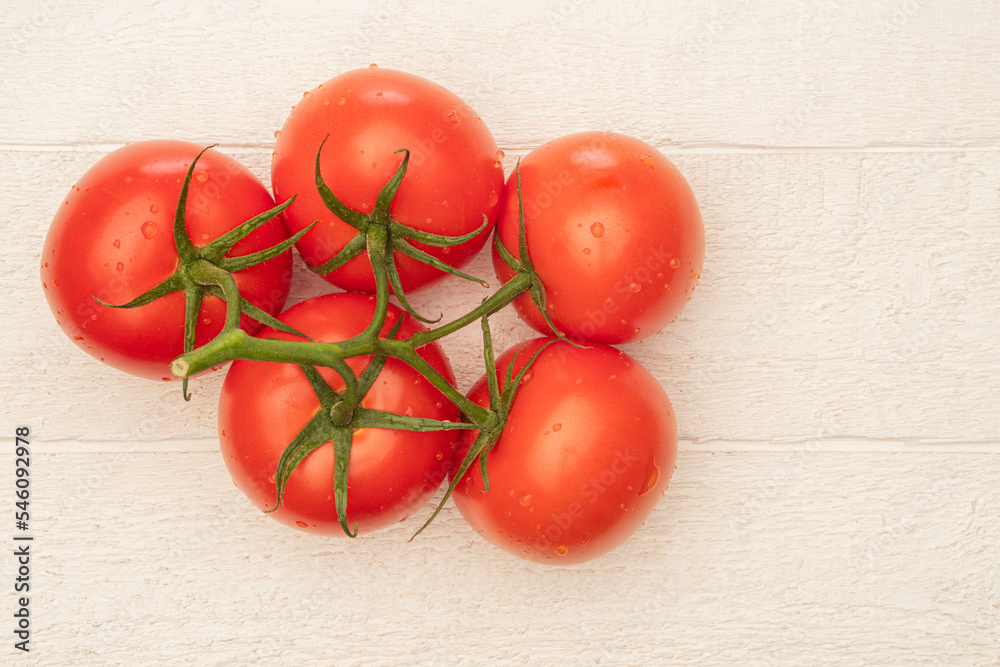 Wall mural fresh vine rippened tomatoes on a white farm table