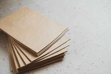 A stack of craft paper envelopes on a table.