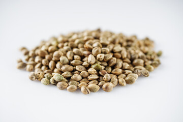 natural hemp seeds on a white acrylic background