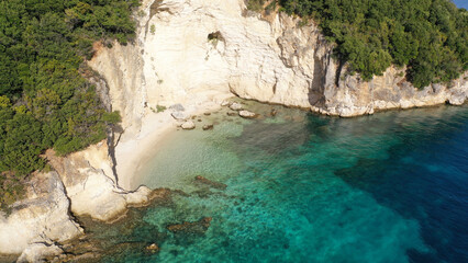 Aerial drone top down photo of tropical exotic paradise secluded rocky bay with deep turquoise sea forming a blue lagoon