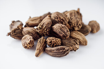 barrel dried black cardamom on a white background