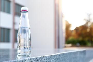 Bottle of water on step outdoors, closeup