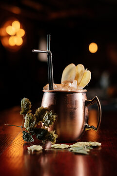 Cocktail in a copper mug with hops