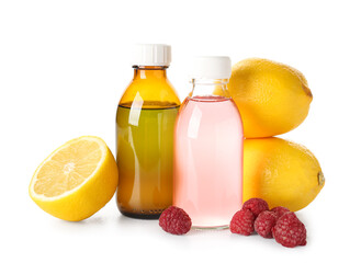 Bottles of cough syrup, lemons and raspberries on white background