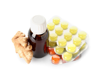 Pills for sore throat, cough syrup and ginger on white background