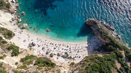 Aerial drone top down photo of tropical exotic paradise secluded rocky bay with deep turquoise sea forming a blue lagoon