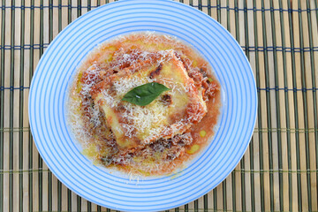 lasagna white and bolognese sauce with parmesan cheese, pasta, tomato, basil, herbs, delicious food from Italian and French cuisine