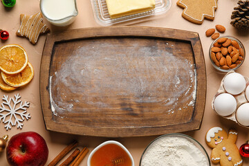 Composition with wooden cutting board and ingredients for Christmas cookies on color background, closeup