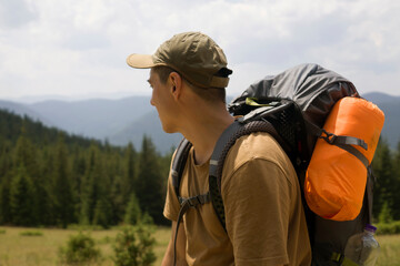 Young man is trekking, hiking in the mountains.