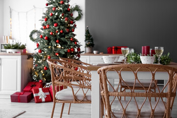 Interior of kitchen with Christmas trees and dining table
