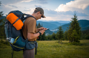 Young man is trekking, hiking in the mountains.