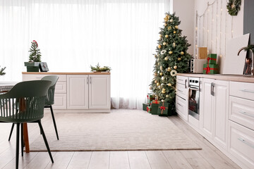 Interior of kitchen with Christmas trees and white counters