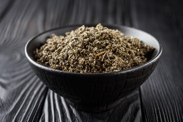 aromatic green dried sage on a black wooden rustic background