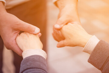 A man and a woman holds  hands and support each other.