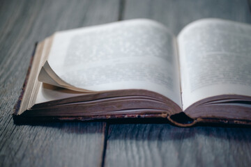 open old book on wooden desk background