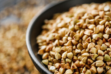 organic raw green buckwheat on a black background