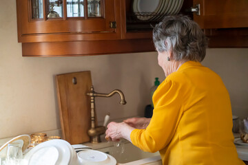 Grandmother is cleaning her house, is young at heart,