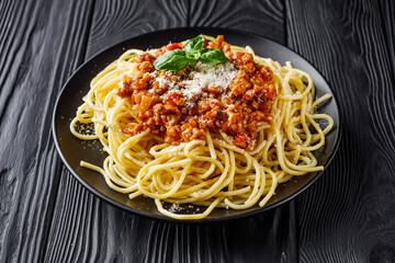 delicious Bolognese pasta on a black plate