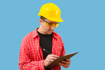 Builder or worker in a construction helmet on a blue background