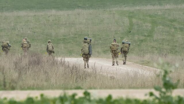 a unit of British army soldiers on a military tab tabbing exercise, Wiltshire UK