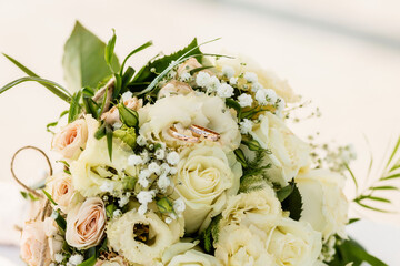 Wedding bouquet and rings close-up.