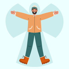 Young man lying in snow on back and moving arms and legs. Smiling man making snow angel. Winter entertainments concept.