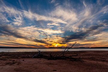 Low water level and sunset at Thunderbird lake in Oklahoma.