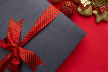 gift box with various Christmas ornaments around it