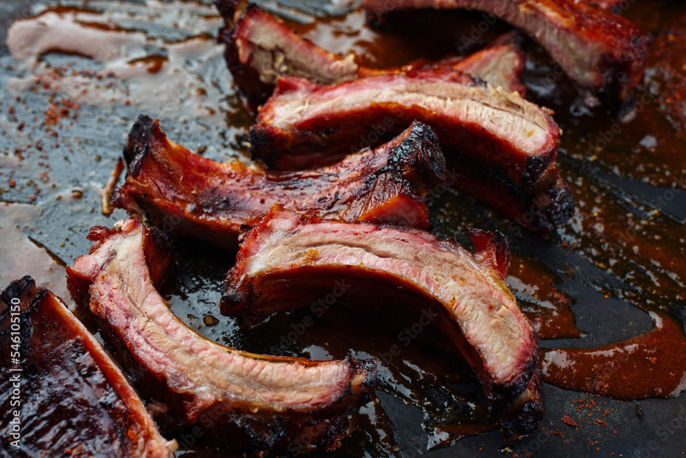 Wall mural barbecue pork spare loin ribs st louis cut with hot honey chili sauce served as close-up on a rustic