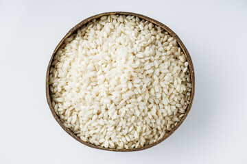 arborio rice for risotto on a white acrylic background