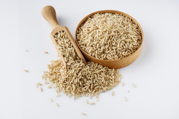 raw unpolished rice on a white acrylic background