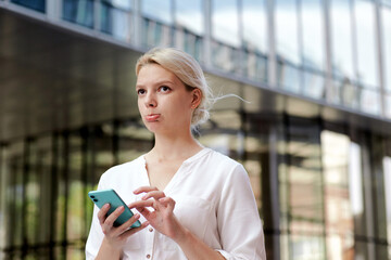 Professional business woman disapointed irritated girl keeping mobile phone outside. Professional...