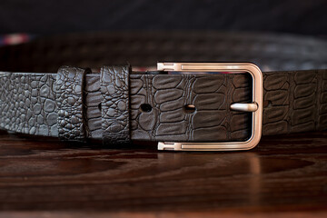 Leather trouser belt in the background . Men's  fashion accessories closet. Genuine leather,...