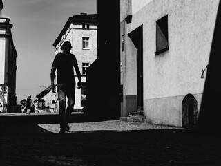 silhouette of the man on the street of small town, people on the streets