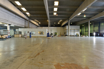 An empty industrial building with polished concrete floors and skylighted ceilings