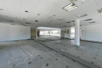 Offices of an industrial warehouse with technical ceilings and floors with gutters without paving