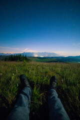 Night view of High Tatras from Panska Hola, Low Tatras National Park Slovakia.Green meadows and mountains in the background. Sitting under the night sky. © Filip