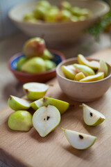 Delicious organic pear fruit on the kitchen worktop. Natural wooden background.