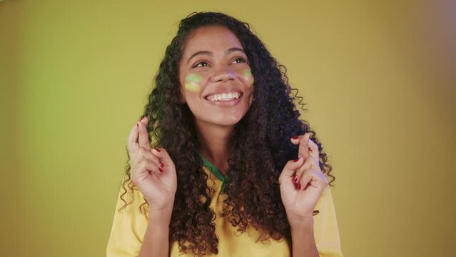 Black woman, soccer fan from Brazil, cheering, desiring, wanting a lot.