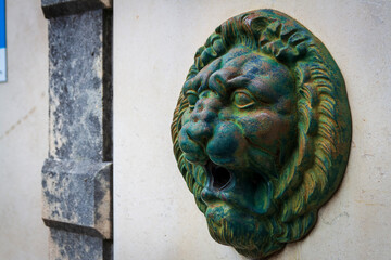 Montbonnot France 13 11 2022 aged bronze lion head gargoyle fountain