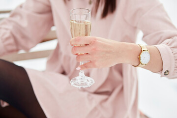 Woman holds a glass of champagne outside. Happy New Year s Eve