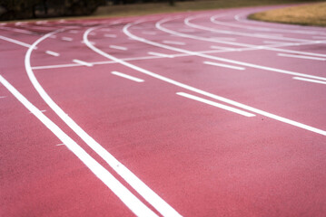 Curved lines on a running track fade into the blurred distance.