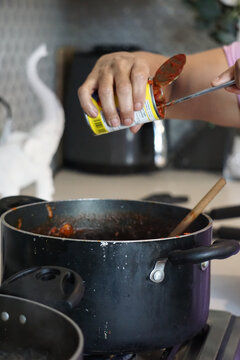 Cooking In The Kitchen Woman Making Italian Tomato Spaghetti Sauce Family Pasta Family Recipe Home Made Woman Brown Cooking For Dinner