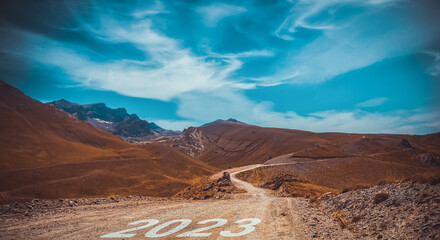 2023 written on mountain road. Concept for new year 2023.
