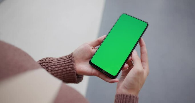 Woman hold with cellphone with chroma key