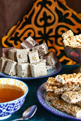 A plate with halva from sunflower seeds and other oriental sweets, a selective focus.