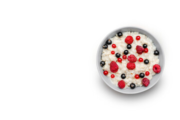 Oatmeal porridge with summer raspberry, currant berries. Porridge oats in bowl with fruits. Healthy...