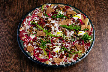 marble beef carpaccio with sauce and herbs